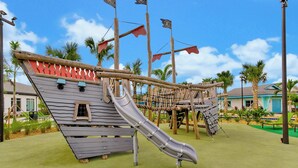 A playground with a pirate-themed slide and rope bridges. - Disney Villa w/ Pool & 2 Resort Clubhouses (Kissimmee)