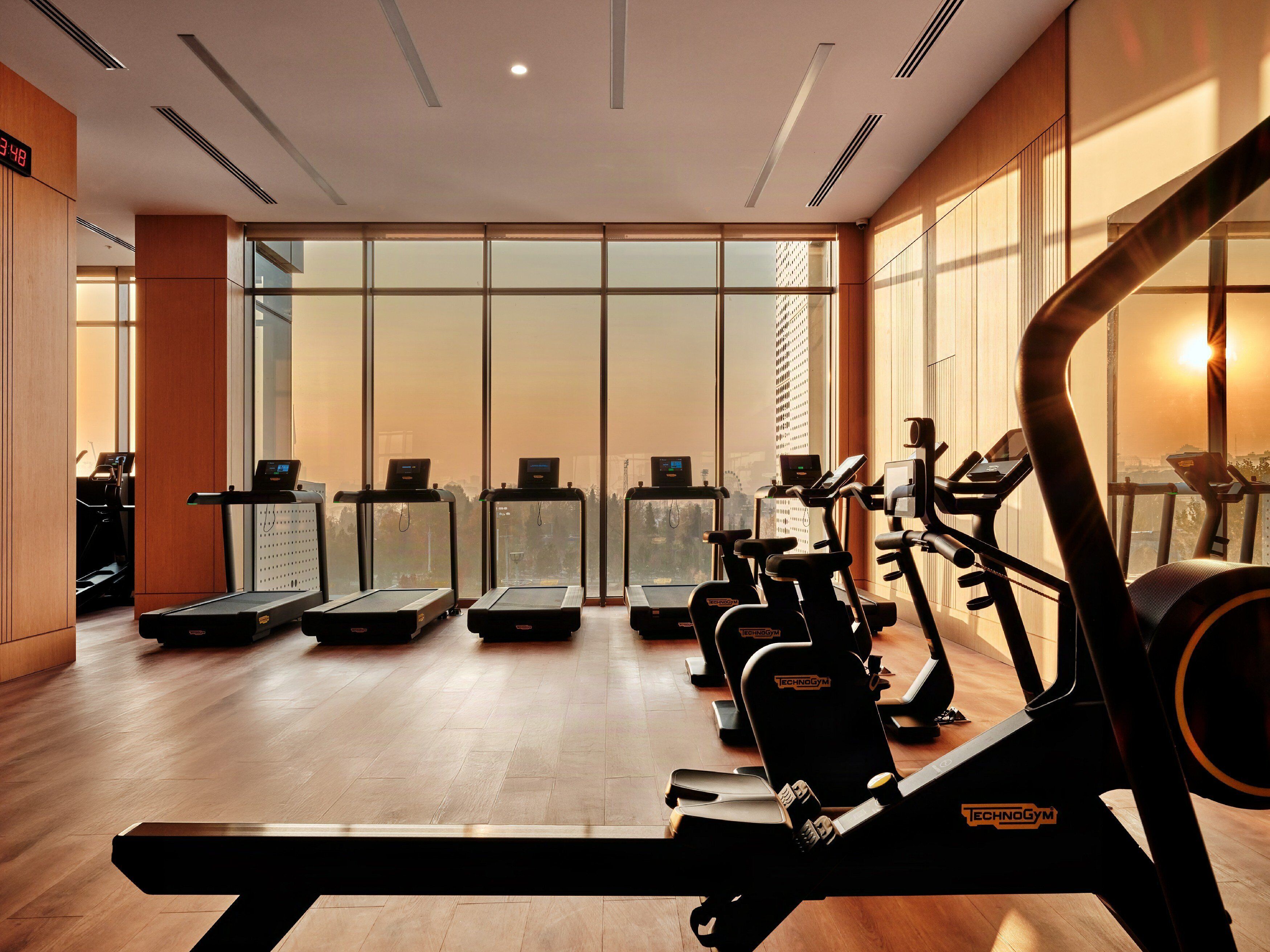 A gym with treadmills, elliptical machines, and weight machines.