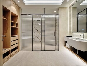 A modern bathroom with a wooden vanity, a glass shower enclosure, and a marble-topped sink. - Crowne Plaza Dushanbe by IHG (Dushanbe)