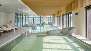 A modern indoor pool with clear water, large windows, and a wooden ceiling. - Intercontinental New Taipei Hot Spring by IHG (New Taipei City)