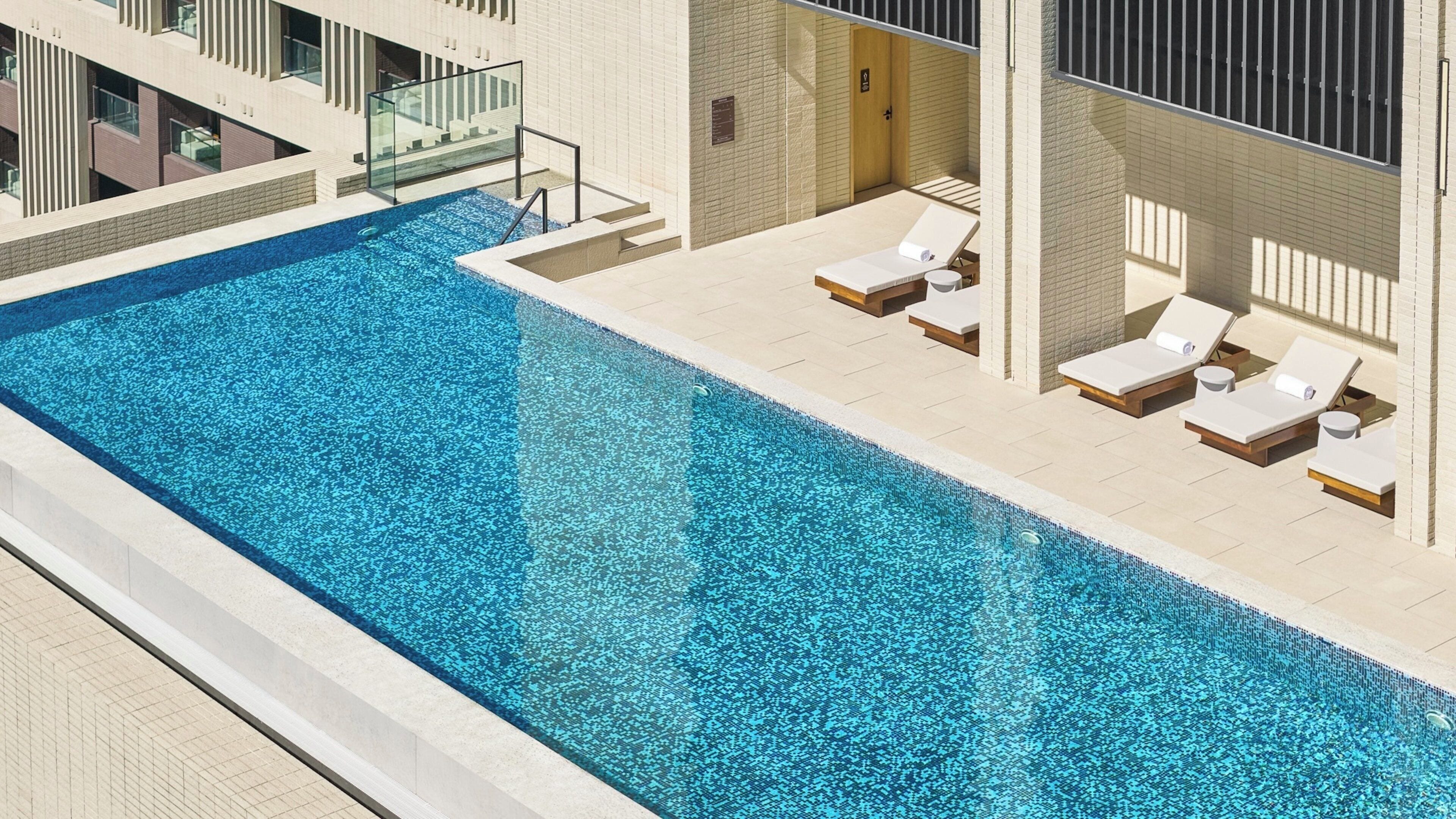 Outdoor pool, pool loungers, lifeguards on site