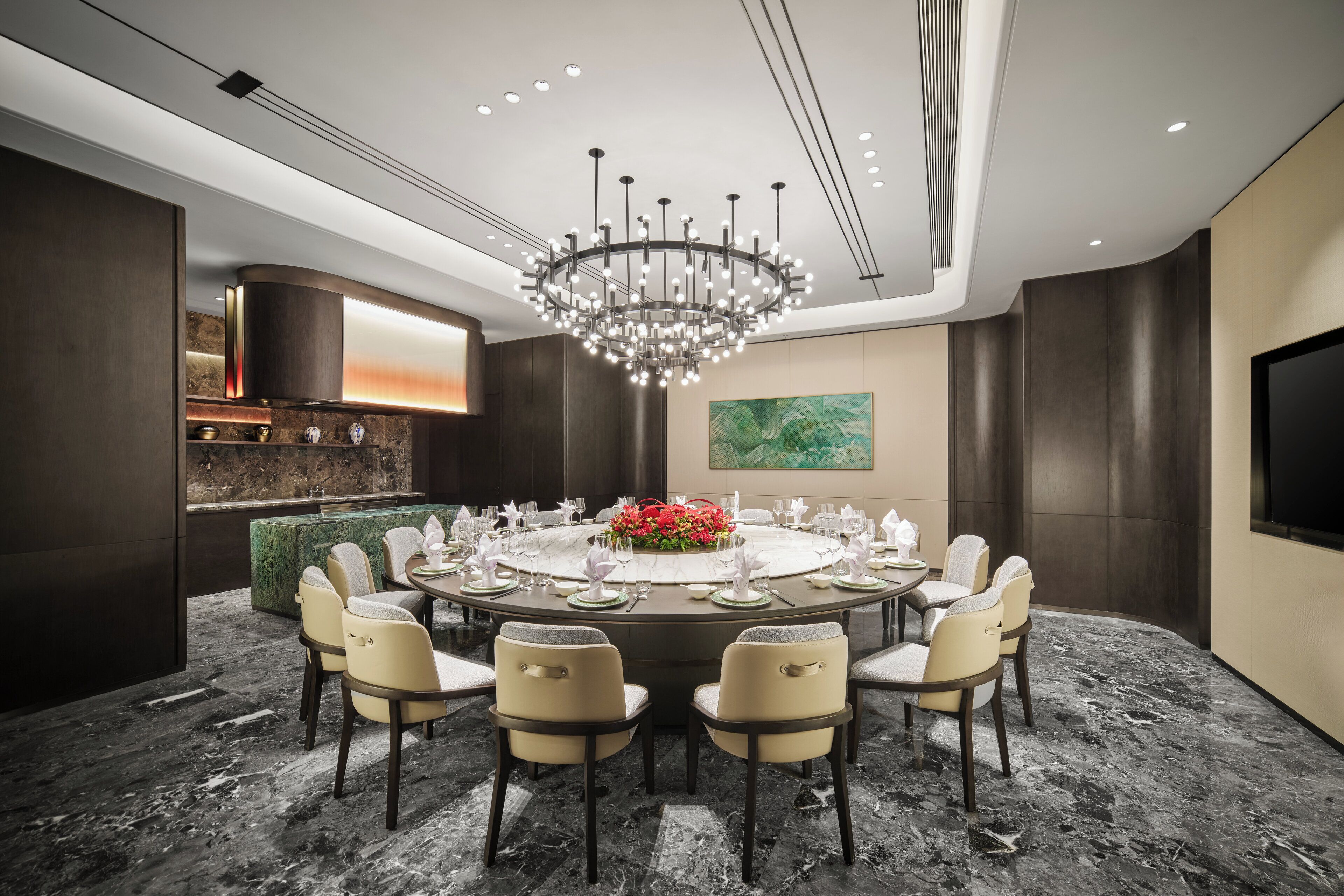 A modern dining room with a round table set for six, surrounded by six chairs.