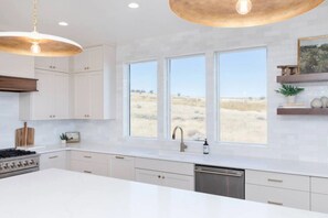 Coffee/tea maker, paper towels, dining tables, kitchen islands