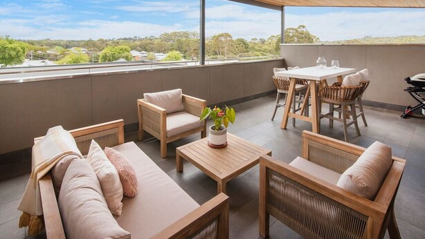 A spacious outdoor seating area with wooden furniture and a view of the surrounding landscape. - Luka on Town View Terrace (Margaret River)