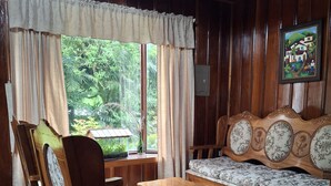 A wooden-paneled room with a sofa, chairs, and a table. - Unique, spacious, and comfortable Chalet in ideal Monteverde location. (Monteverde)