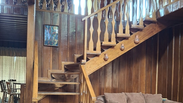 A wooden interior with a staircase, a sofa, and a dining area. - Unique, spacious, and comfortable Chalet in ideal Monteverde location. (Monteverde)