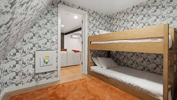Habitación con literas, papel tapiz estampado, cabecero de madera y alfombra marrón.