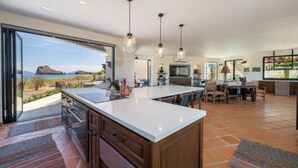 A spacious kitchen with a large island, open-plan layout, and a view of the landscape. - Beachfront home & mountain views, and the biggest private pool (Loreto)