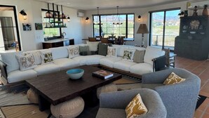 A modern living room with a sectional sofa, a coffee table, and a fireplace. - Beachfront home & mountain views, and the biggest private pool (Loreto)