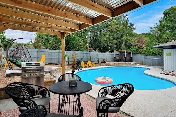 Relax poolside under the shaded patio with BBQ and dining space
