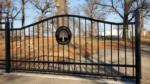 A gated entrance with a sign for 'Period Tiny Home RV Resort'. - Big Cabin Hideaway Tiny Home (Big Cabin)