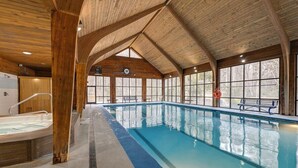 An indoor swimming pool with wooden beams, a hot tub, and large windows. - Mountain Views, Hot Tub & Resort Amenities in Sapphire, NC (Sapphire)