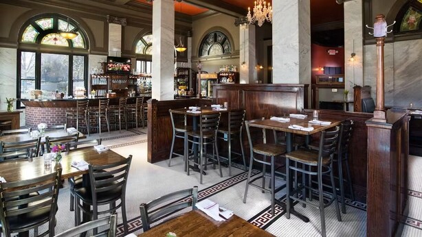 A spacious restaurant with high ceilings, large windows, and a bar area. - Chicopee House ~ Your 4 bd, 3 bath, Athens Getaway 1-mile to Sanford Stadium! (Athens)