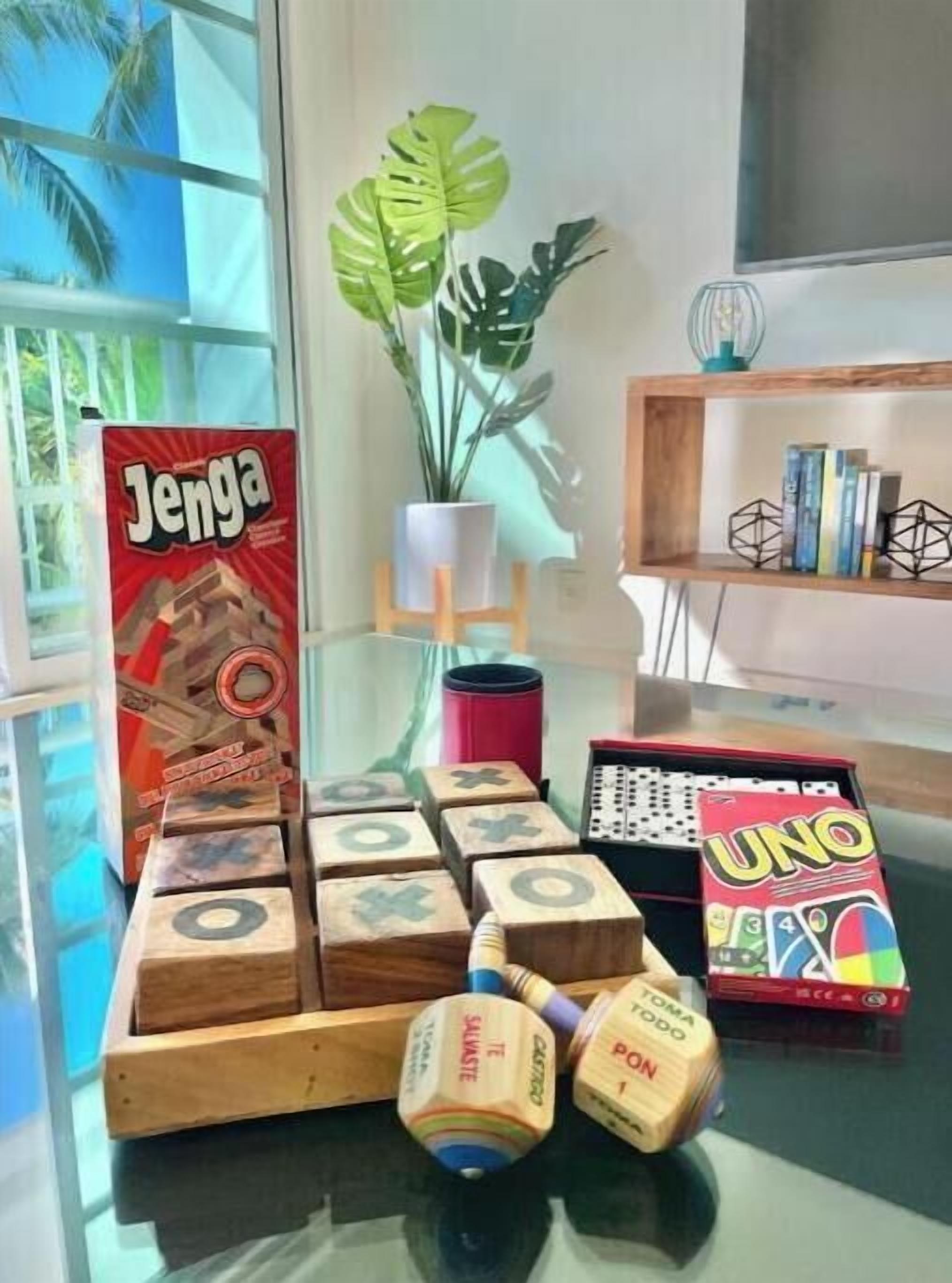 A table with Jenga, UNO, and wooden blocks.