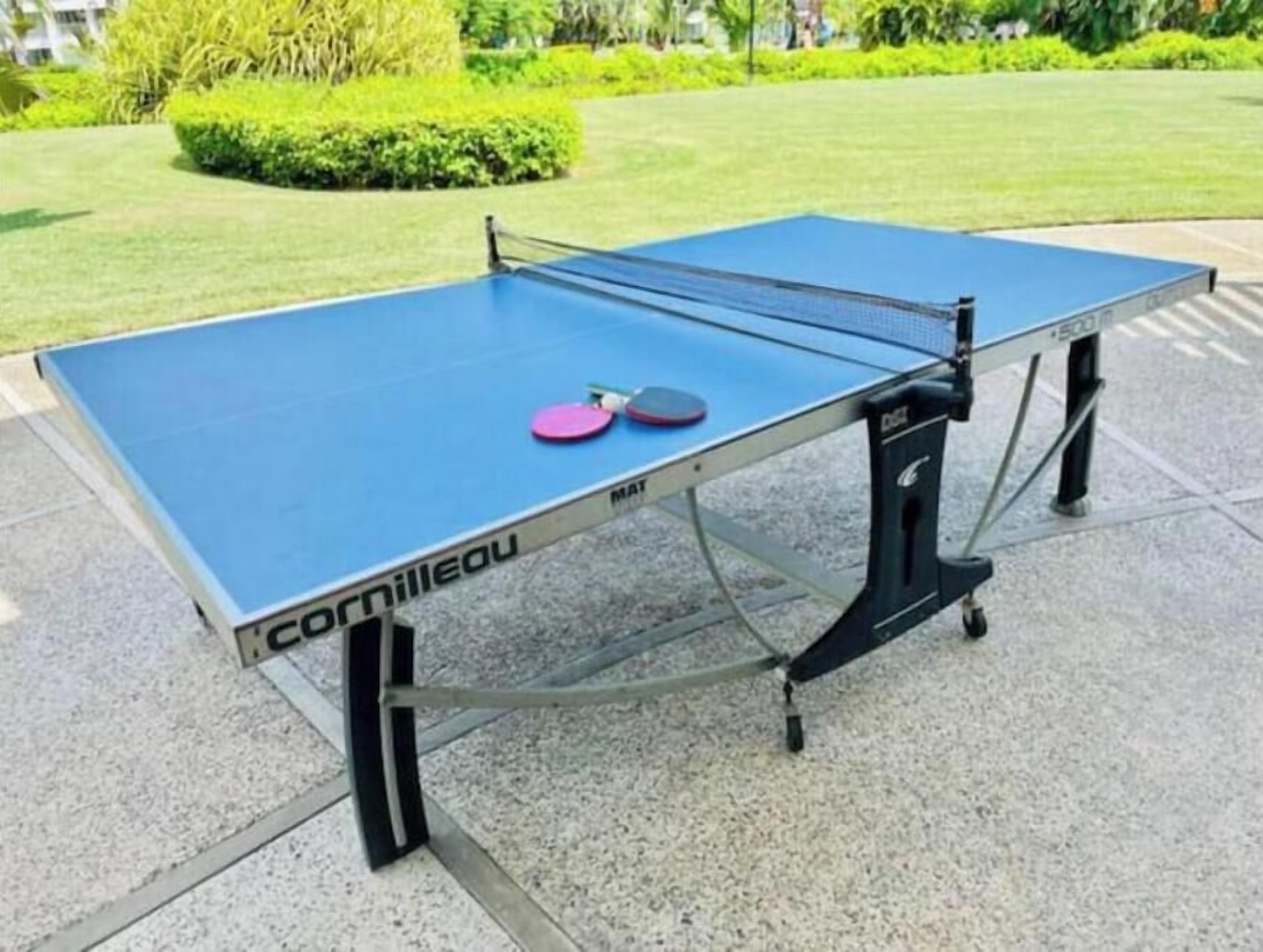 A table tennis table with a blue playing surface, branded with 'Cornilleau' and 'MATT'.