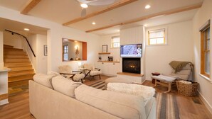 A modern living room with a fireplace, a television, and a cozy seating area. - Spacious 3-bedroom townhome in Durango with mountain views, perfect for families. (Durango)