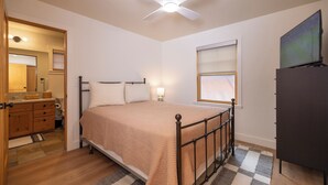 A bedroom with a bed, a ceiling fan, a window, and a dresser. - Spacious 3-bedroom townhome in Durango with mountain views, perfect for families. (Durango)