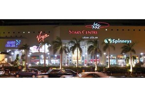 A Stars Centre building with a Virgin sign and a Spinneys sign.