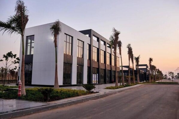 A modern building with a flat roof and large windows.