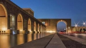 A long, arched bridge with evenly spaced columns and a pathway running alongside it.