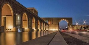A long, arched bridge with evenly spaced columns and a pathway running alongside it. - Casa De Madinaty (Second New Cairo Qism)