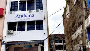 A building with a sign reading 'Andiana Hotel & Lodge.'