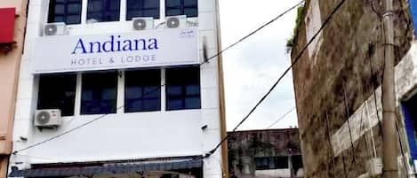A building with a sign reading 'Andiana Hotel & Lodge.'