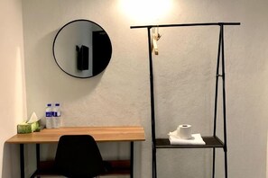 A room with a desk, chair, round mirror, and a small shelf with toiletries. - Andiana Hotel & Lodge (Kota Bharu)