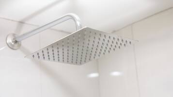 A modern showerhead with a curved handle and a square, perforated design.