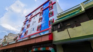 A multi-story building with a sign for Shivaka Inn Residency.