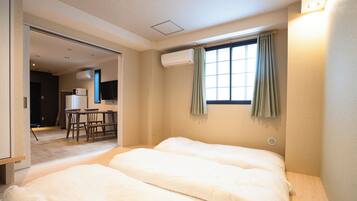 A hotel room with a bed, a desk, and a television.