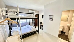 A bunk bed room with a hanging rack, a desk, and a view of the outside. - Lamoon 90s (Hat Yai)