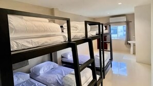 Bunk beds in a hotel room with a bathroom and a window. - Lamoon 90s (Hat Yai)