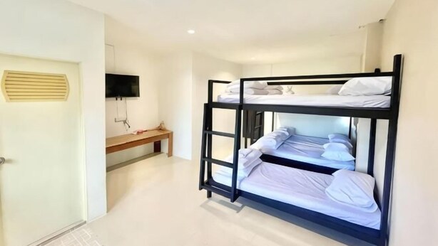 A bunk bed room with a desk and a TV. - Lamoon 90s (Hat Yai)