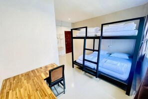 A room with bunk beds, a wooden desk, and a chair. - Lamoon 90s (Hat Yai)