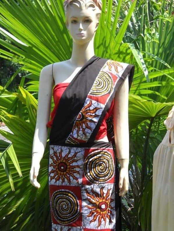 A mannequin dressed in a red top and a patterned skirt with sun designs. - The Dutch Inn (Galle)