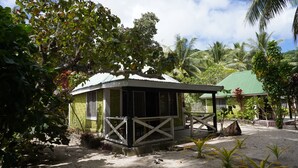 A small, single-story building with a green roof and a porch. - White Sandy Beach Eco Lodge (Naviti Island)