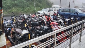 A row of motorcycles parked on a metal railing. - Hotel Little Panda - Narkanda (Kumharsain)