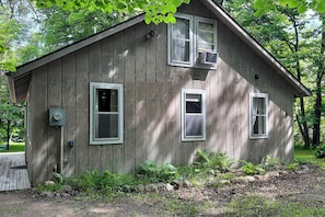A wooden cabin with two windows, a door, and a small porch. - Charming Getaway: Rustic Cabin on West Battle Lake (Clitherall)