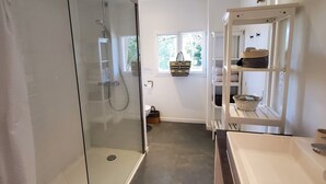A modern bathroom with a glass-enclosed shower, a large sink, and a vanity with a basket. - Independent studio with pool (Nîmes)