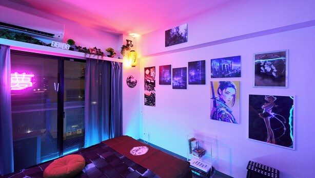 A room with a bed, a small stool, and wall-mounted artwork. - Tokyo Shinjyuku Cyber Room (Tokyo)