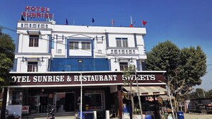 A two-story building with a sign for "Hotel Sunrise & Restaurant Sweets". - Sunrise Hotel & Restaurant (Danta Ramgarh)