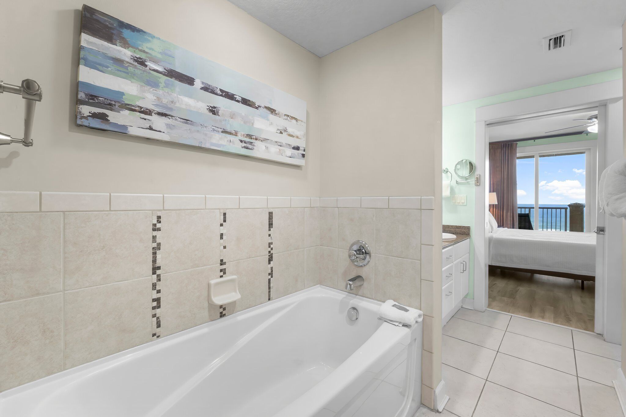 A modern bathroom with a bathtub, a shower, and a vanity with a mirror.