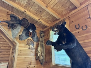 A room with wooden walls and ceiling, a mounted bear head, and a mounted horse head. - Dale Hollow Cabin · 3 Levels · Hot Tub · Huge Fire Ring · Sleeps 10 (Jamestown)