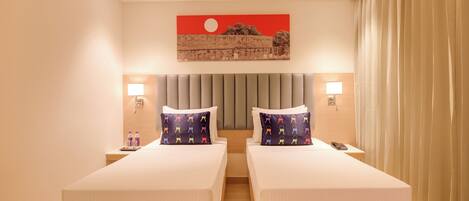 A hotel room with two beds, a large painting on the wall, and a view of the cityscape.