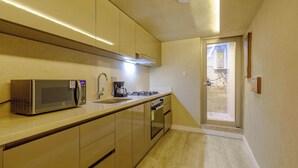 A modern kitchen with a microwave, stove, and sink.