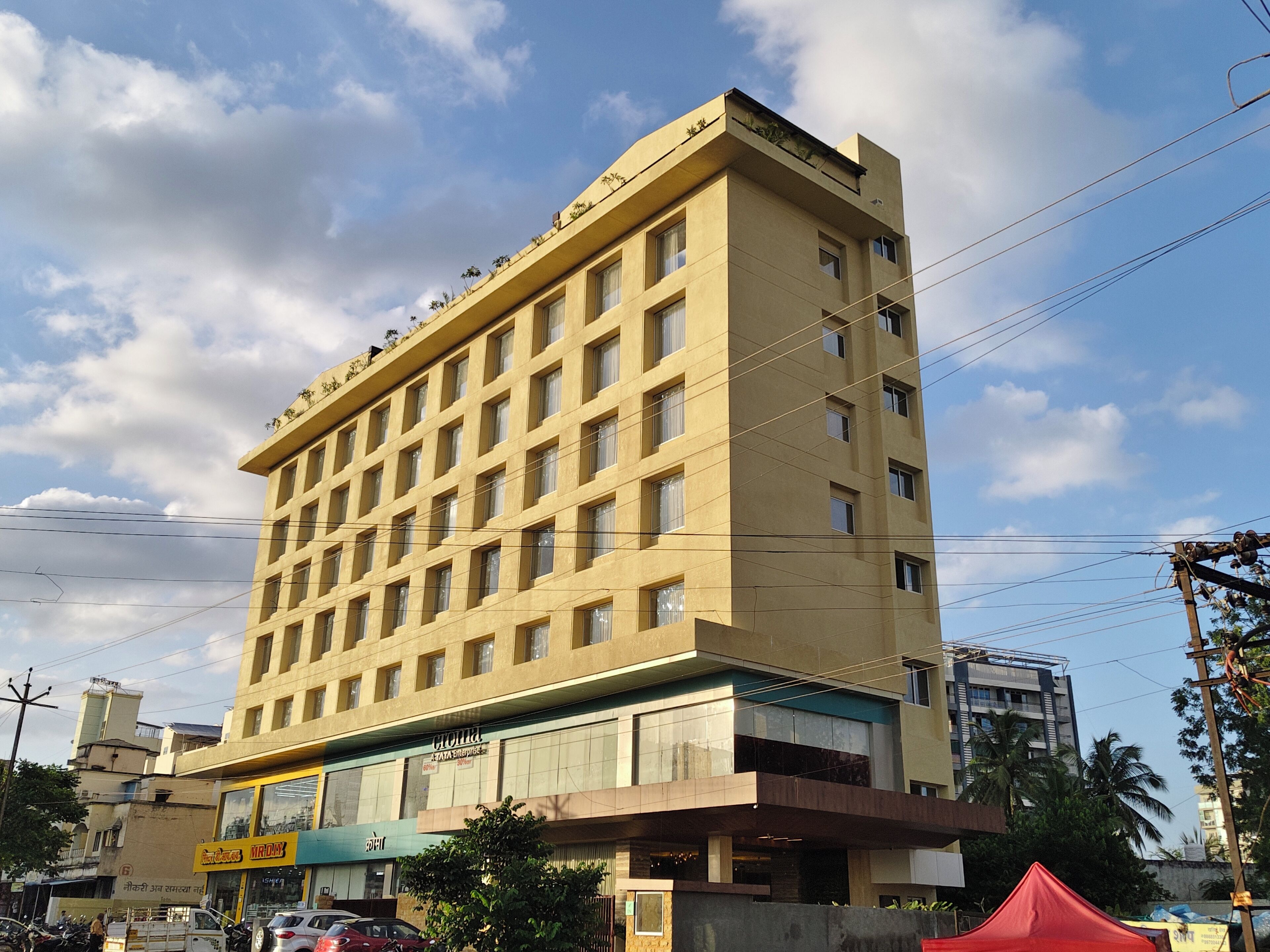 A multi-story hotel with a flat facade, large windows, and a ground-level commercial space.