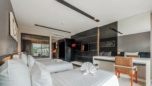 A modern hotel room with two beds, a desk, and a chair. - 1BR with Pool 3 Min Walk to Beach  C197 (Patong)