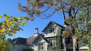 A traditional house with a stone facade, a central entrance, and a driveway leading to the main entrance. - The Ryebeck Hotel (Bowness-on-Windermere)