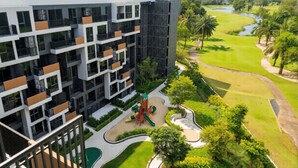 A modern hotel with a rooftop terrace, a playground, and a golf course view. - Laguna SkyPark new brand apartments (Choeng Thale)